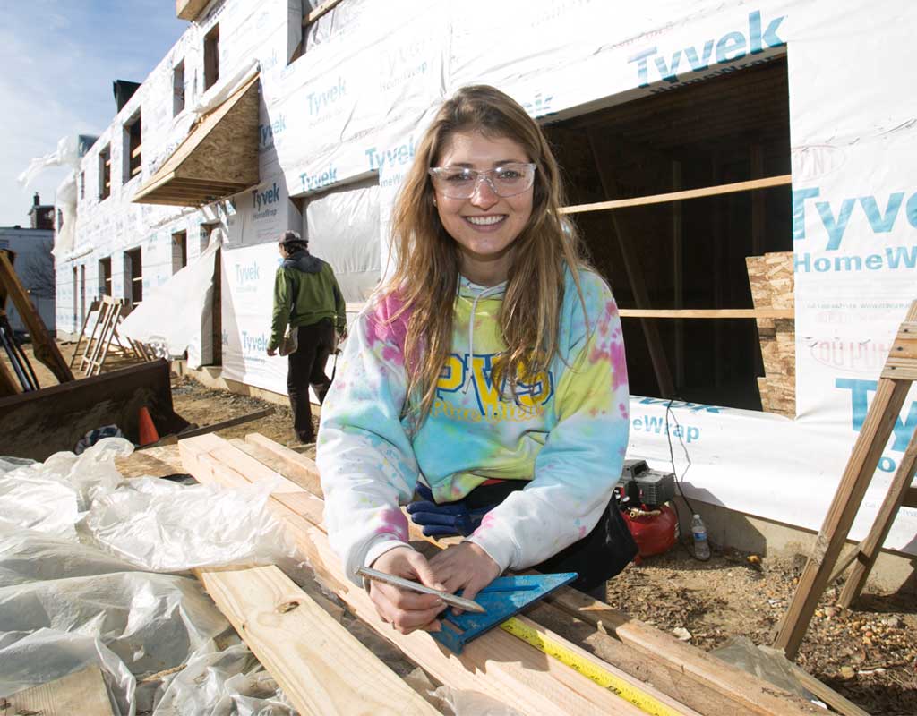 Female student working on building new classroom