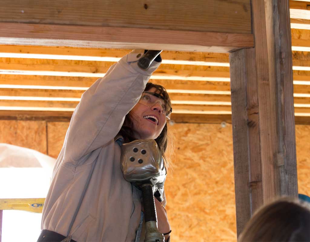 Female PTSEM student working on framework for new classroom