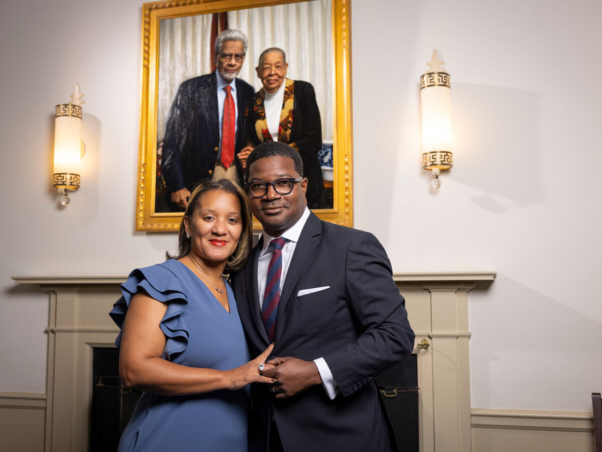 President Walton and his wife in front of a Presidential painting