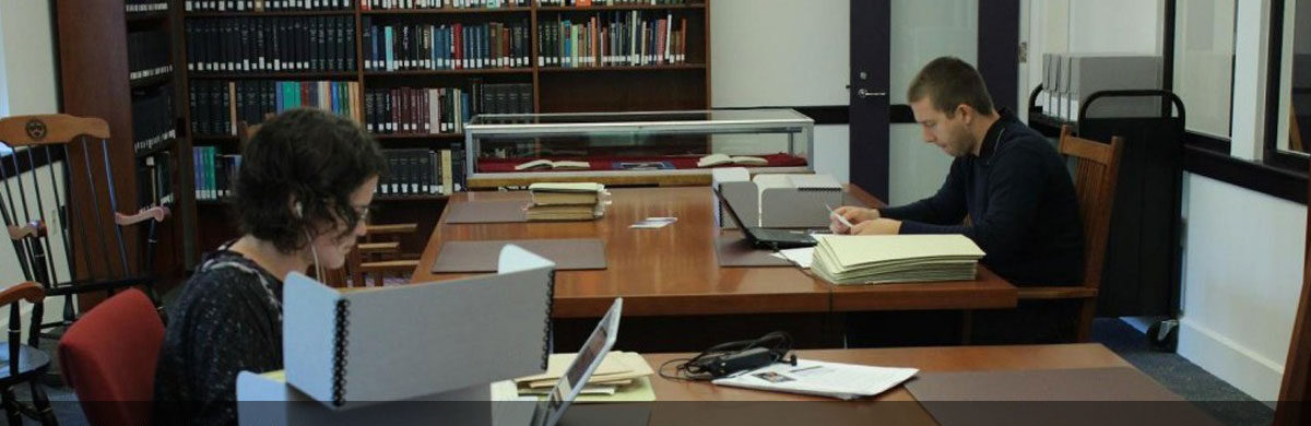 Two students studying in the library Barth Center
