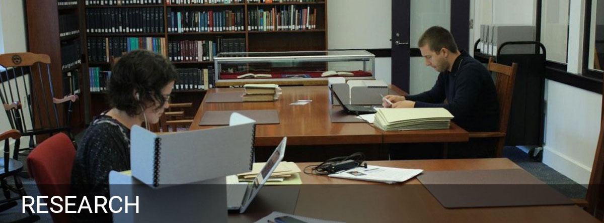 Two students studying in the library Barth Center