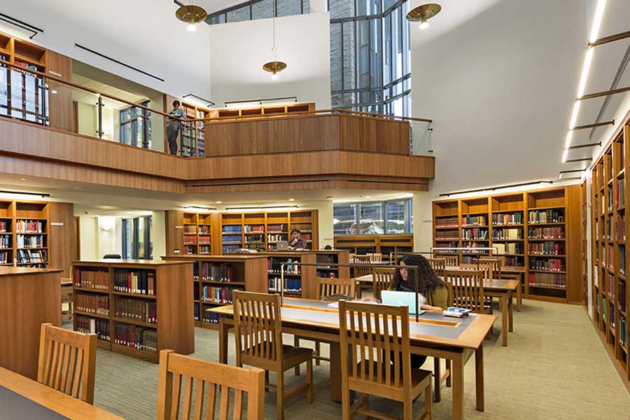 photo of Wright Library Reference Reading Room with bookcases lining the walls, plentiful study space and natural light