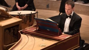 K. Heimann playing the harpsichord
