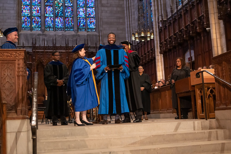 Princeton Theological doctoral student is hooded on stage during graduation ceremony