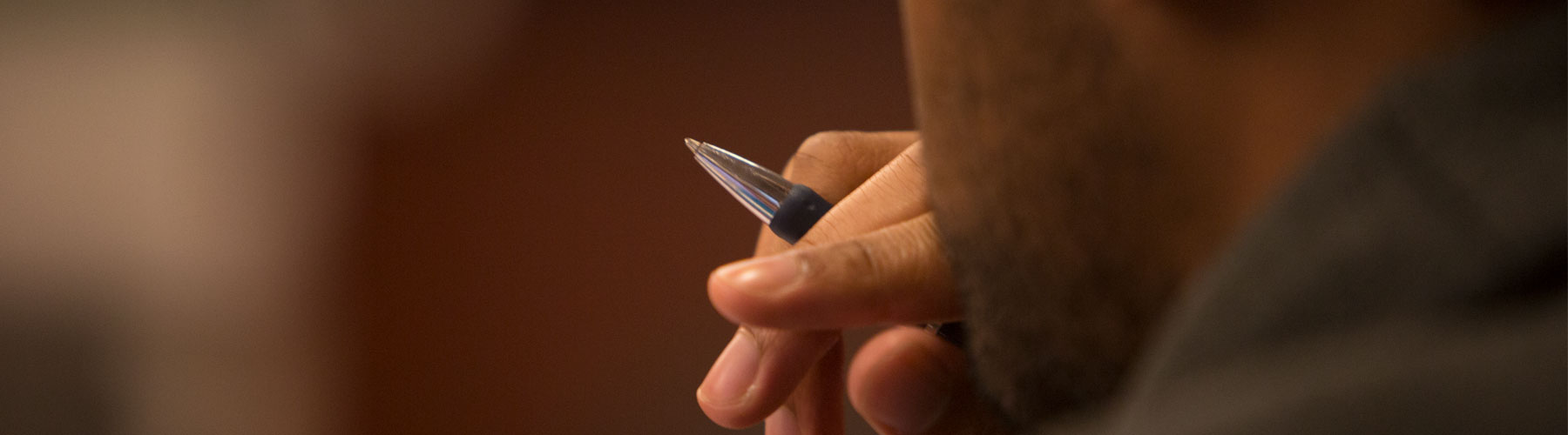 Student with a pen closeup