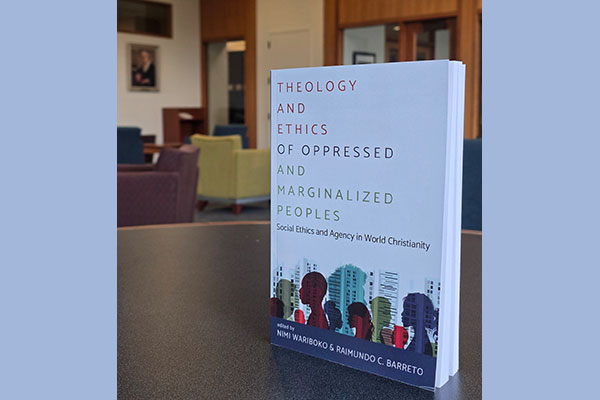 photo of the book Theology and Ethics of Oppressed and Marginalized Peoples edited by Nimi Wariboko and Raimundo C. Barreto on a table in Wright Library at Princeton Theological Seminary