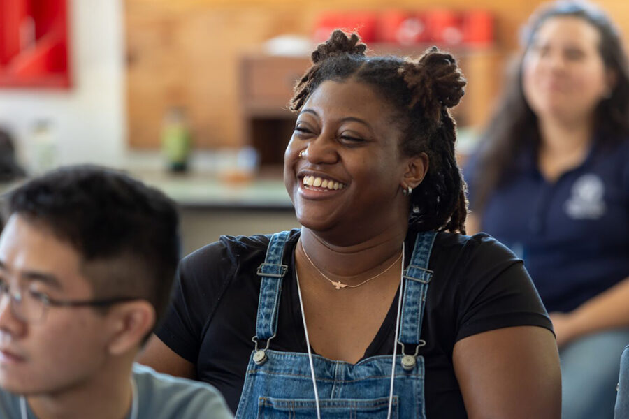 Student sitting at desk smiling