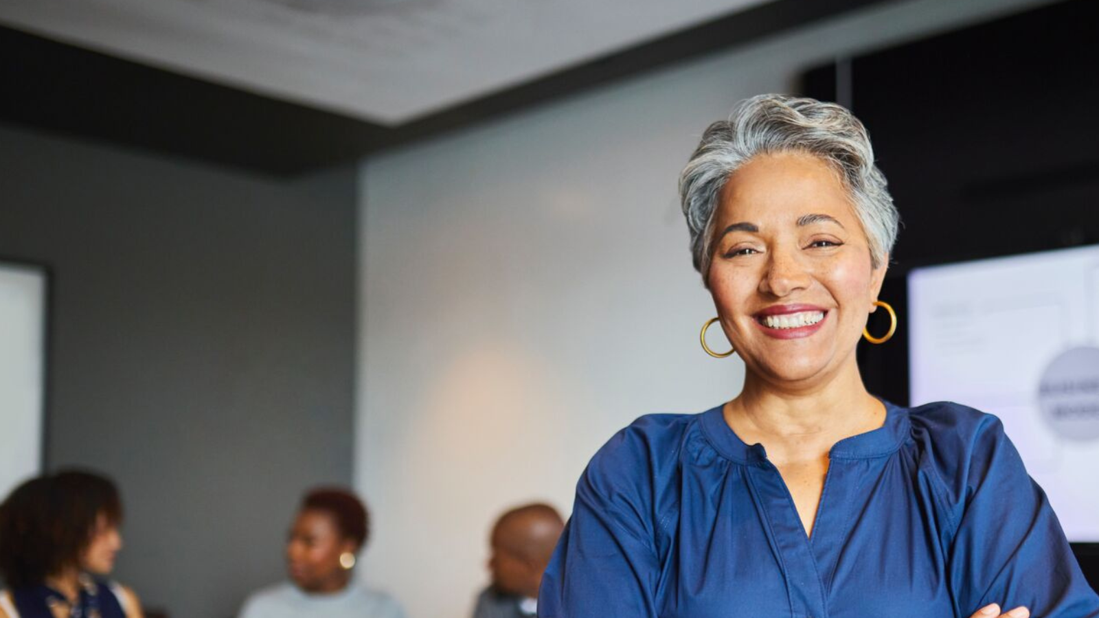 Woman standing in front of office meeting